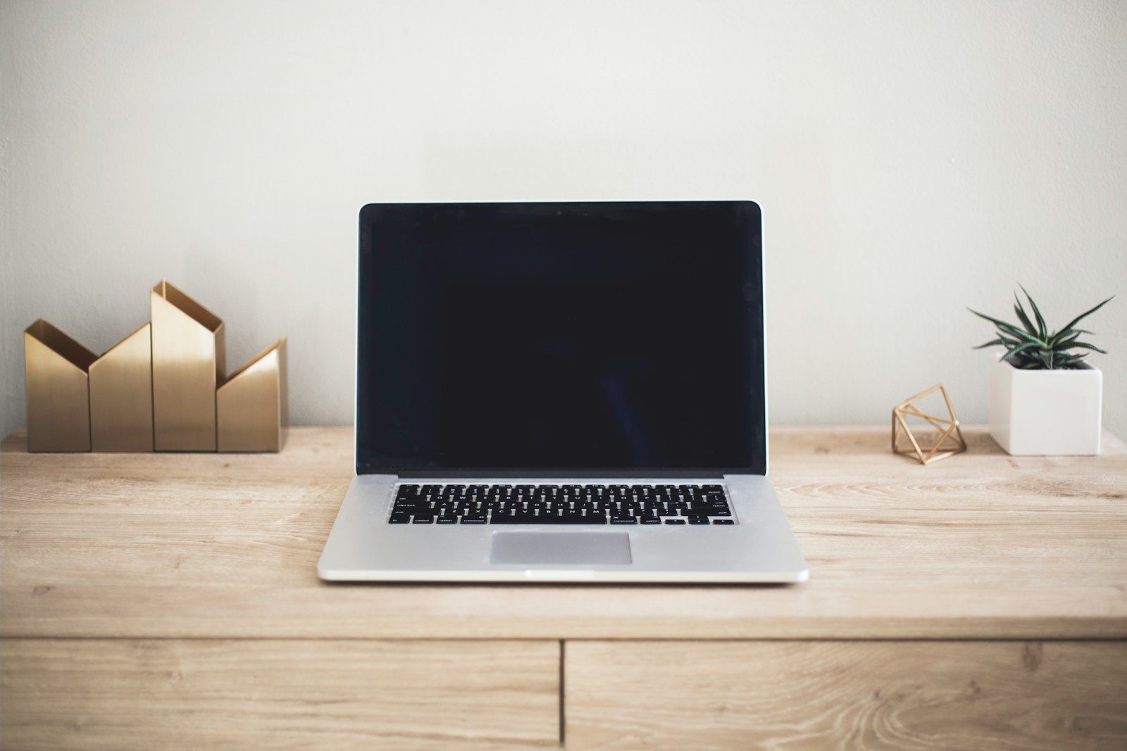 Laptop on a wooden desk used for website design